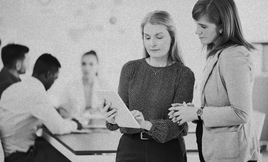two women looking at a tablet